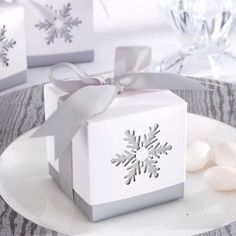 a white box with a snowflake design on it and some candy in front of it