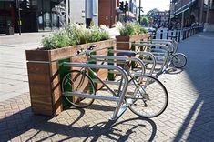 there are many bikes that are parked on the side of the street in front of each other