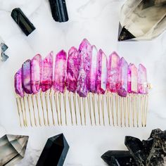 "Large Mauve Pink Angel Aura Rainbow Quartz Hair Comb For those who want something particularly memorable on their big day, we offer our new full crown option. This comb features a huge array of mauve pink angel aura quartz points on a gold-tone comb. Perfect for weddings, parties or as a birthday gift! Our products are one of a kind, and the photos feature the exact comb you will receive. This piece measures approximately 11cm wide and 7cm high. The crystals measure between 4.7cm - 2.3cm. This Pink Aura Quartz, Using Crystals, Ruby Quartz, Dragon Queen, Jewelry By Brand, Crystal Hair Accessories, Crystal Hair Comb, Pink Aura, Lucky Brand Jewelry