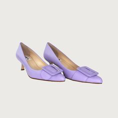 Experience the heightened allure of your everyday essential kitten heel, accentuated by a striking buckle that transforms it into a statement-making pump. It's worth noting, this style stands as our top-seller. The perfect pointy toe mid heel pump! Narrow at toe box Leather upper w/ leather buckle Leather lining Heel Height 2.5" Made in Italy Purple Heels With Buckle Closure For Formal Occasion, Elegant Lavender Heels With Round Toe, Elegant Lavender Heels For Formal Occasions, Almond Toe Kitten Heels With Buckle Closure For Office, Office Kitten Heels With Almond Toe And Buckle Closure, Office Kitten Heels With Buckle Closure And Almond Toe, Elegant Lavender High Heels, Purple Low Heel Leather Heels, Lavender Pointed Toe Heels For Formal Occasions