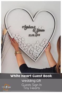 a white heart guest book with flowers on it