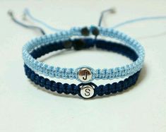 two blue and white bracelets with initial charms