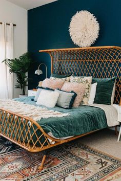 a bed that has some pillows on it and a rug in front of the bed