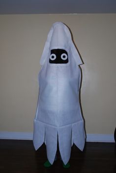 a white towel with a black face and eyes in the shape of a ghostly ghost