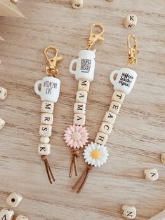 three key chains with words and flowers on them