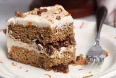 a piece of carrot cake on a plate with a fork