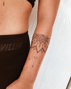 a woman's arm with a tattoo on it, showing her lower body and the upper half