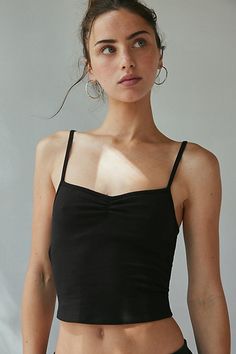 Better-than-basic Out From Under cami in a slim & cropped fit. Designed in a soft & stretchy cotton blend knit featuring a sweetheart neckline, spaghetti straps and pinch-front detail at the bust for a modern finish. Only at Urban Outfitters. Features Out From under Bec pinch front cami Fitted tank top Soft and stretchy knit Sweetheart neckline with spaghetti straps Pinch-front detail at the bust Sleeveless Slim stretch fit Cropped length Adjustable spaghetti straps Easy pull-over style UO exclu Fitted Cotton Crop Top With Built-in Bra, Basic Fitted Cropped Tank Top, Fitted Basic Cami Crop Top, Fitted Cotton Cami Crop Top, Fitted Basic Camisole Crop Top, Everyday Fitted Cotton Crop Top, Fitted Cotton Crop Top For Night Out, Fitted Cotton Crop Top For Everyday, Fitted Tank Top