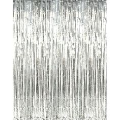 silver foil fringe curtain hanging on a white wall in front of a black and white background