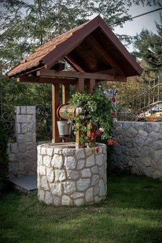 an outdoor gazebo with potted plants and flowers in the corner on top of it