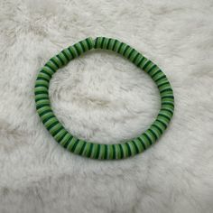 Beautiful handmade bracelet featuring three shades of green Heishi clay beads on a stretchy band. Size of bracelet in photo: 7 1/2 inches Bracelets Clay, Heishi Bead Bracelet, Clay Bead Bracelets, Heishi Bracelets, Clay Bead Bracelet, Clay Bead, Stackable Bracelets, Heishi Beads, Bead Bracelets