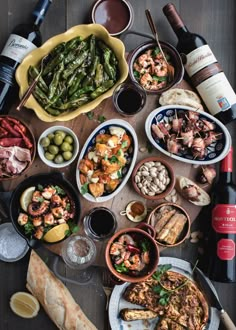 an assortment of food and wine on a table