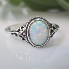 Dainty Opal Ring. Best Seller. For Your Consideration Is This Oh So Pretty 925 Sterling Silver And Opal Ring. Simple, Comfortable, And Beautifully Crafted. Face Height On This = 10mm. An Oval Fiery White Lab Opal Is The Star. A Little Oxidized Detailing Is A Great Accent To This Lovely Oval Opal Stone. Ref:Sid-F26 Opal And Silver Ring, Oval Moonstone Ring In Fine Jewelry Style, Oval Cabochon Moonstone Ring, White Oval Adjustable Rings, Oval Stackable Rings In White Gold And Sterling Silver, Adjustable White Oval Rings, White Oval Cabochon Ring As Gift, White Oval Cabochon Ring For Gift, White Opal Promise Ring Oval Cabochon