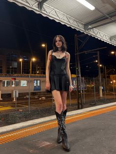 Black Silk Dress With Cowboy Boots, Cowboy Boot Night Outfit, Black Outfit Cowboy Boots, Cowboy Boot Outfits Grunge, Cowboy Boots Rock Outfit, Cowboy Boot Outfits Dress, Goth Cowboy Boots Outfit, Black Cowgirl Boots Outfit Concert