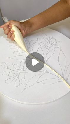 a person is using a large knife to cut out designs on a piece of paper