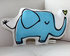 an elephant pillow sitting on top of a white couch