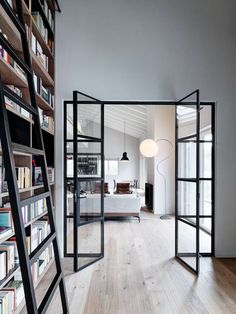 an open room with bookshelves and ladders on the floor in front of it