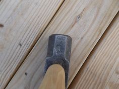 an old hammer is stuck in the wood