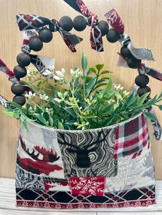 a vase filled with flowers on top of a wooden table