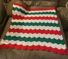 a crocheted blanket sitting on top of a couch