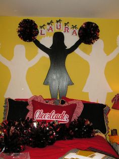 a bedroom decorated with cheerleaders and decorations for the wall above the headboard