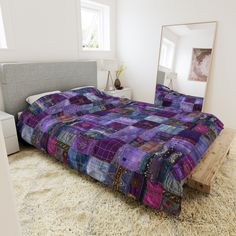 a bed sitting on top of a white rug next to a mirror in a bedroom