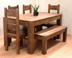 a wooden table with two benches and a potted plant