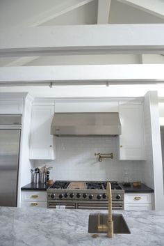 a kitchen with marble counter tops and stainless steel appliances in the center, before and after remodeling