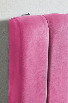 two pink towels are hanging on the wall