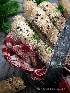 sesame seed bread sticks and a knife on a table