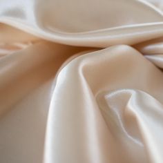 Designer dead stock fabric in a silky champagne polyester charmeuse. Canadian designer. Beige Silk Satin Party Dress, Beige Silk Satin Dress For Party, Elegant Cream Satin Dress, Formal Cream Silk Satin Dress, Elegant Cream Satin Wedding Dress, Elegant Cream Silk Satin Dress, Gold Satin Bias Cut Dress, Beige Silk Satin Evening Dress, Beige Satin Dress For Evening