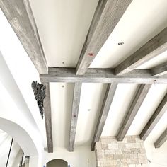 the interior of a house with exposed wood beams