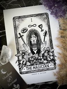 the magician tarot card is next to some crystals