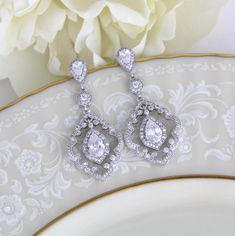 "Vintage style dangle earrings have the drama of 1920's platinum and diamond jewelry. At 1 3/4\" h x 3/4\" w, these beautiful bridal earrings are a must-have for the bride seeking a one-of-a-kind design for her wedding day! With silver pave scrolls and micro pave dangles, these CZ earrings have the elegance of genuine vintage heirlooms. Matching necklace; https://www.etsy.com/listing/261838550/art-deco-necklace-crystal-wedding" Classic Cubic Zirconia Chandelier Earrings For Wedding, Wedding Diamond Drop Earrings With Intricate Design, Intricate Design Diamond Drop Earrings For Wedding, Classic Silver Chandelier Earrings For Wedding, Classic Chandelier Earrings With Intricate Design For Anniversary, Wedding Earrings With Intricate Drop Design, Wedding Chandelier Earrings With Intricate Cubic Zirconia Design, Wedding Drop Earrings With Intricate Design, Intricate Drop Earrings For Wedding