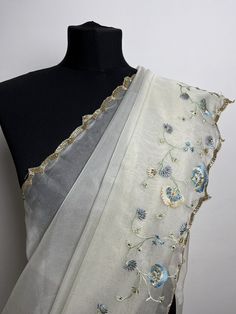 Dainty off white soft organza saree with stone work and pretty floral embroidery in shades of blue. Suitable for day or evening events.  Blouse materiel: Fully embroidered organza #autumnwedding #weddingsaree #elegantsaree #partywearsareesonline #embroideredsarees #daintysarees Organza Pre-draped Saree With Floral Embroidery For Reception, Floral Embroidered Organza Pre-draped Saree For Reception, White Organza Pre-draped Saree For Eid, Organza Saree With Floral Embroidery For Reception, Reception Organza Saree With Floral Embroidery, Bollywood Organza Pre-draped Saree With Floral Embroidery, Festive White Organza Pre-draped Saree, Semi-stitched White Organza Saree, Designer Organza Pre-draped Saree With Floral Embroidery