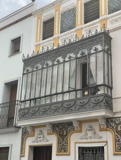 an ornate balcony and balconies on the side of a building with wrought iron railings