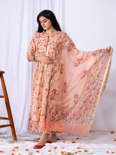 This new modern style kurti comes with a detail of potli button on the yoke and a front gathered ghera. It is paired with a matching print palazzo to give a modern look. This is a complete comfort look for the coming festive days. Comes with a hand-block printed cotton dupatta with tassels. 100% Premium Cotton Printed Suit Set Chanderi Dupatta Comfort fit Set Contents: 1 Kurta, 1 Dupatta, 1 Palazzo Model height is 5.7 feet and is wearing size M Wash Care Instructions: Dry Clean Only Note: The pr Transitional Floral Print Anarkali Set, Transitional Floral Print Kurta, Designer Wear Dupatta With Block Print, Traditional Drape Cotton Palazzo Set, Floral Print Straight Kurta For Navratri, Bollywood Style Straight Kurta With Floral Print, Pink Kalamkari Print Straight Kurta Salwar Kameez, Pink Kalamkari Print Straight Salwar Kameez, Pink Straight Kurta Salwar Kameez With Kalamkari Print