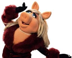 the muppet from the movie miss piggy is posing with her arms in the air