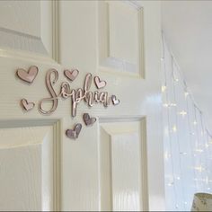 a white door with pink and silver hearts on it that says,'spring '