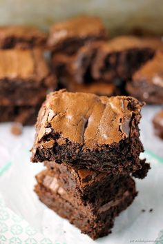 two chocolate brownies stacked on top of each other with one bite taken out of it