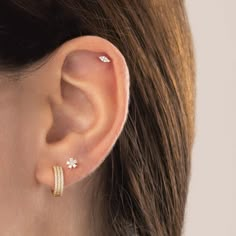 a close up of a woman's ear with two rings on the top and bottom