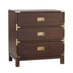 a wooden chest with three drawers and brass handles on the bottom, against a white background