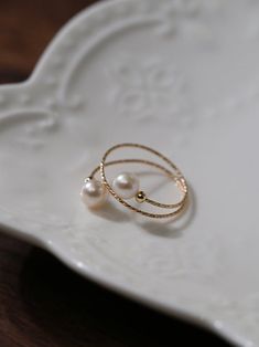 Experience the timeless charm of our 14K Gold-Filled Freshwater Double Pearl Wrapped Wire Ring Elevate any ensemble with its luxurious touch, modern design, adjustable fit, and versatile styling. Make a statement of elegance and sophistication wherever you go. Metal: 14K Gold Filled Gemstone: Freshwater Pearls Pearl Diameter: 5.5-6mm Size: Adjustable 6-8 Weight: 1g Wire Pearl Ring, Elegant 14k Gold Filled Promise Ring, Elegant Silver 14k Gold Filled Rings, Elegant White Gold-plated Rings, Elegant Rose Gold Open Pearl Ring, Elegant Adjustable 14k Gold Filled Rings, Elegant Adjustable Rose Gold Rings, Elegant 14k Gold-filled Promise Ring, Elegant 14k Gold Filled Rings For Anniversary