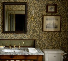 a bathroom with a sink, mirror and toilet in it's centerpieces