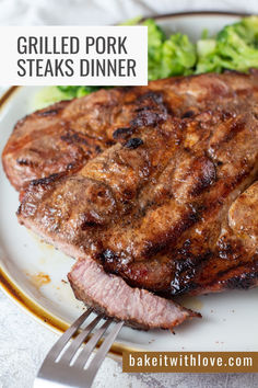 Grilled pork steaks served on an offwhite plate with steamed broccoli and a bite being cut away. Grilled Pork Steaks Recipes, Grilling Pork Steaks, Pork Steak Grilled, Pork Steaks On Blackstone, Bbq Pork Steaks Grilled, Pork Steaks On The Grill, Recipe For Pork Steak, Pork Steak Recipes Grilled, Pork Steaks Recipes