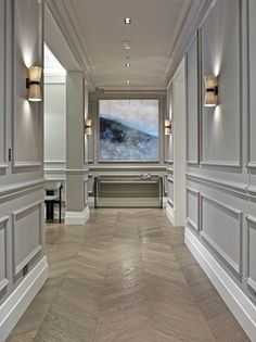 an image of a room with white walls and wood flooring on the bottom level