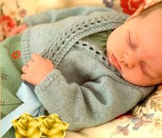 a baby sleeping on top of a blanket