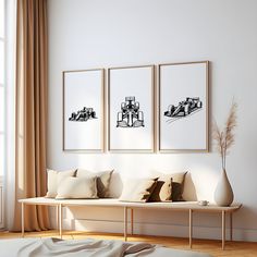 three black and white pictures hang on the wall above a couch