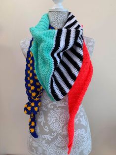 the multicolored scarf is on top of a mannequin