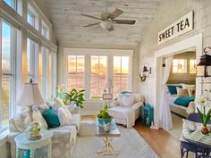 a living room filled with furniture and lots of windows